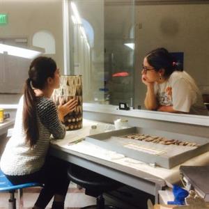 Alyssa Rina discusses a treatment with a visitor In The Artifact Lab, Penn Museum, Philadelphia