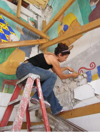 NHR Member Viviana Dominguez working on murals at Ste. Trinite in Haiti; photo by Stephanie E. Hornbeck NHR Member Viviana Dominguez working on murals at Ste. Trinite in Haiti; photo by Stephanie E. Hornbeck