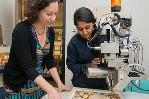 Conservators using analytical equipment.