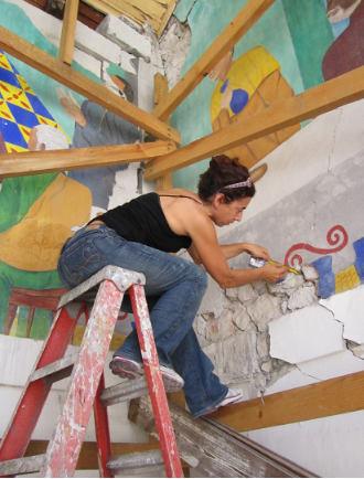 NHR Member Viviana Dominguez working on murals at Ste. Trinite in Haiti; photo by Stephanie E. Hornbeck