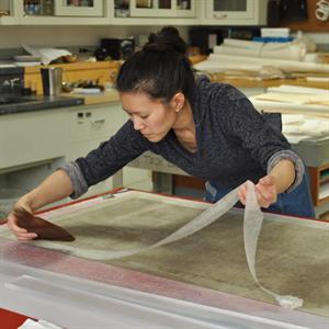 Grace Jan remounting a silk painting at the Freer|Sackler