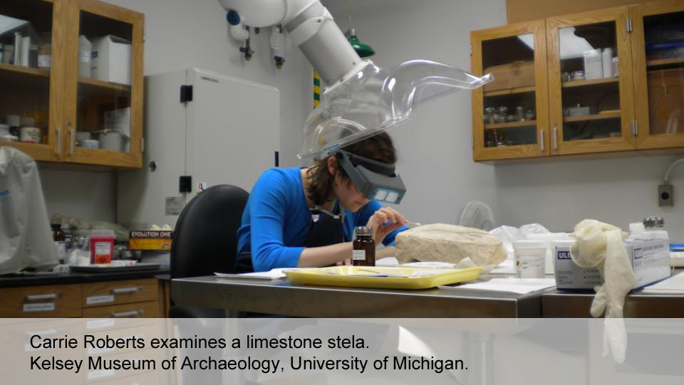 Carrie Roberts examines a limestone stela.